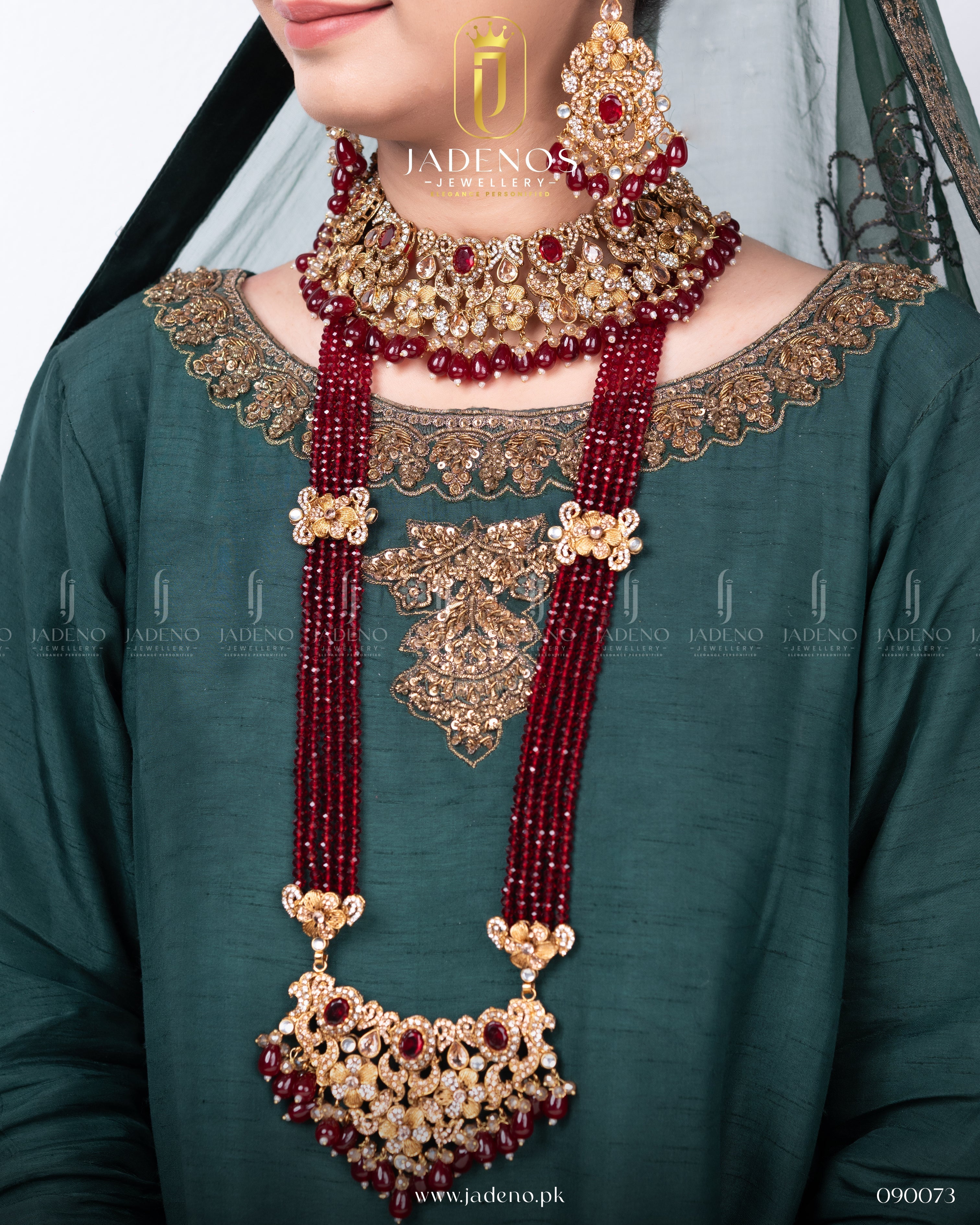 close-up of Traditional Rangreza Bridal Set With Maala, Tika and Jhumar with red beads and gold detailing