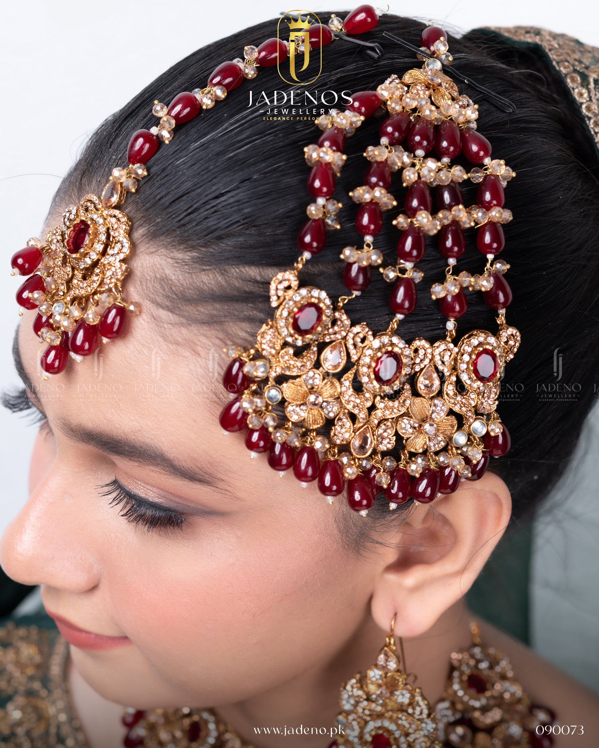 Close-up of Traditional Rangreza Bridal Set With Maala, Tika and Jhumar featuring red bead jhumar and gold stone detailing