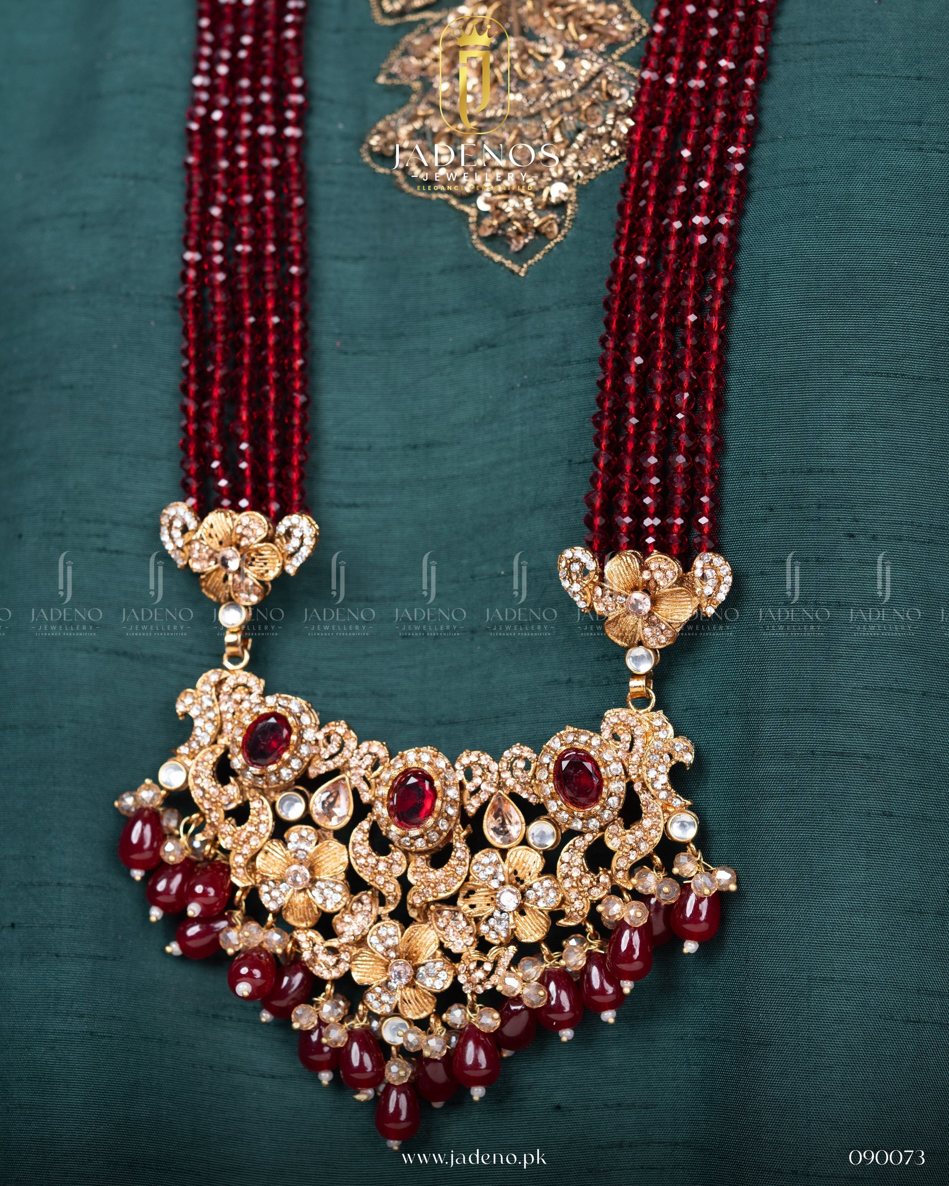 Close-up of Traditional Rangreza Bridal Set With Maala, Tika and Jhumar pendant with red beads and gold detailing