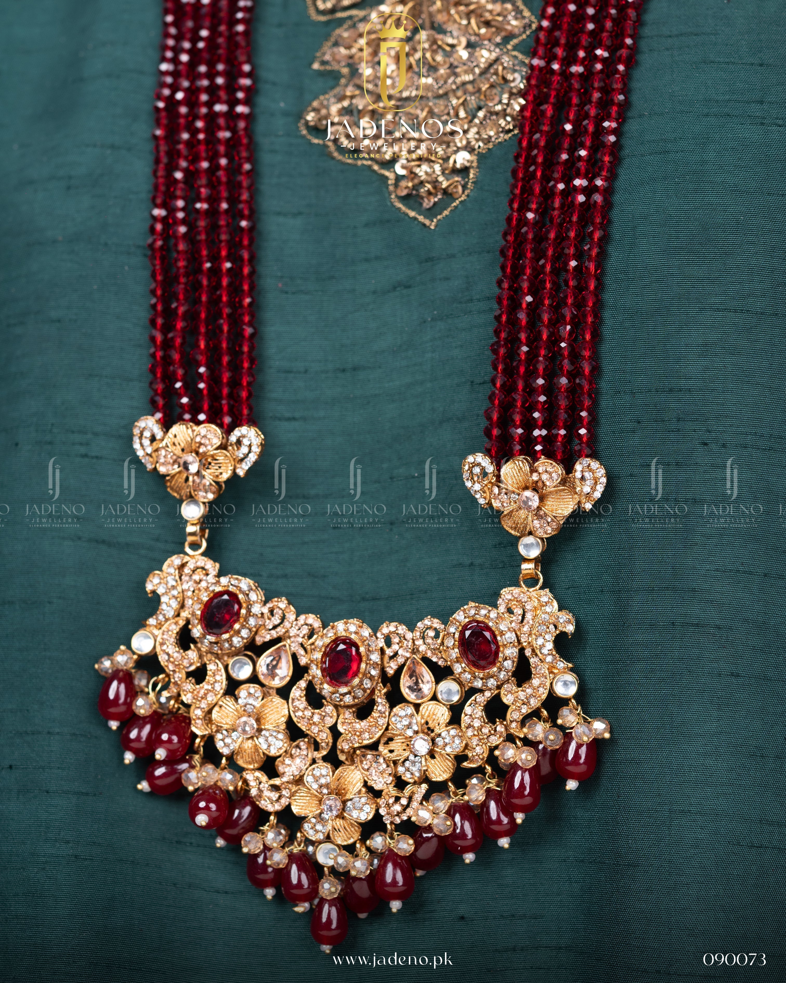 Close-up of Traditional Rangreza Bridal Set With Maala, Tika and Jhumar pendant with red beads and gold detailing