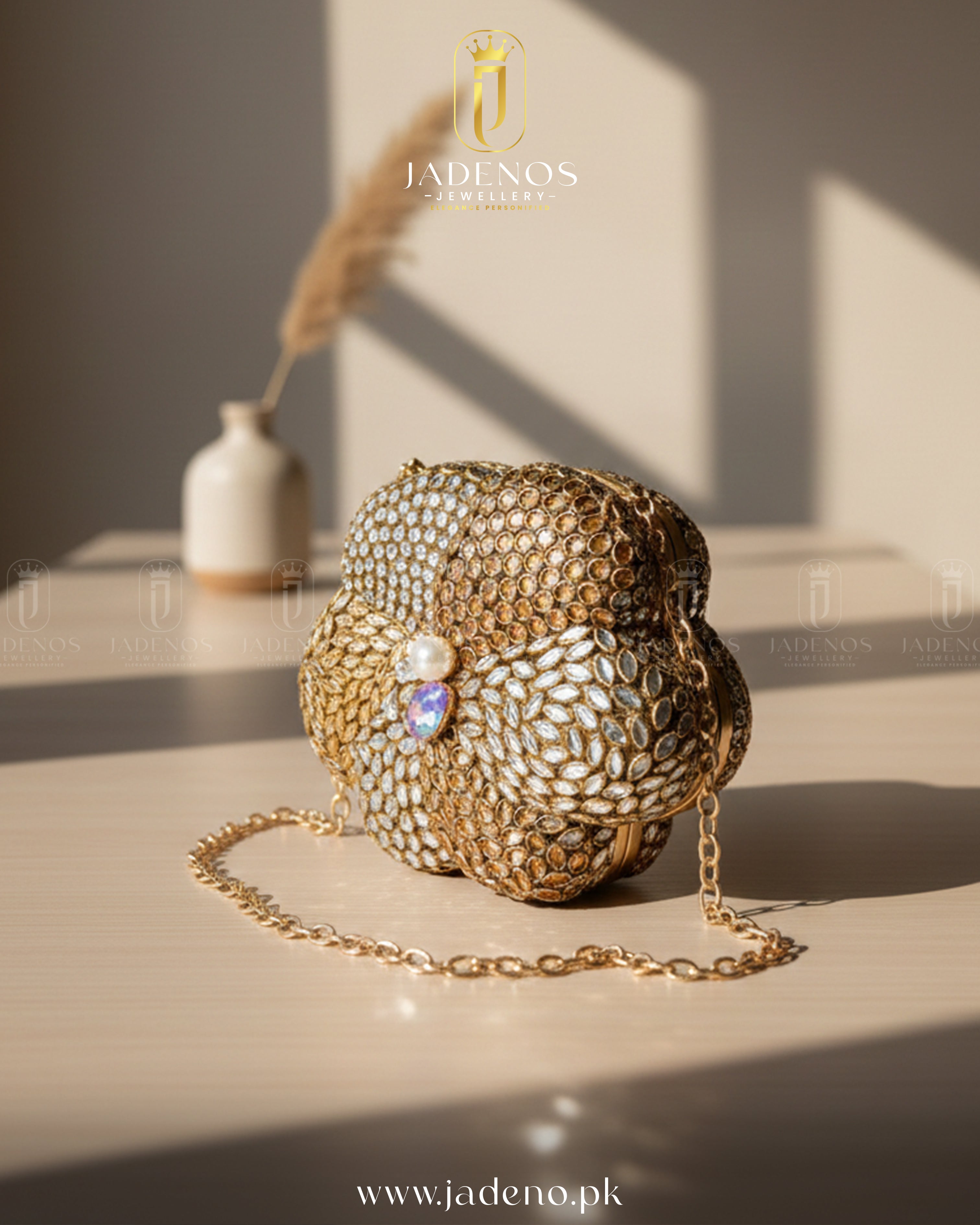 The Scarlet Core Clutch featuring gold floral craftsmanship, crystal detailing, pearl centerpiece, and chain strap in warm natural light